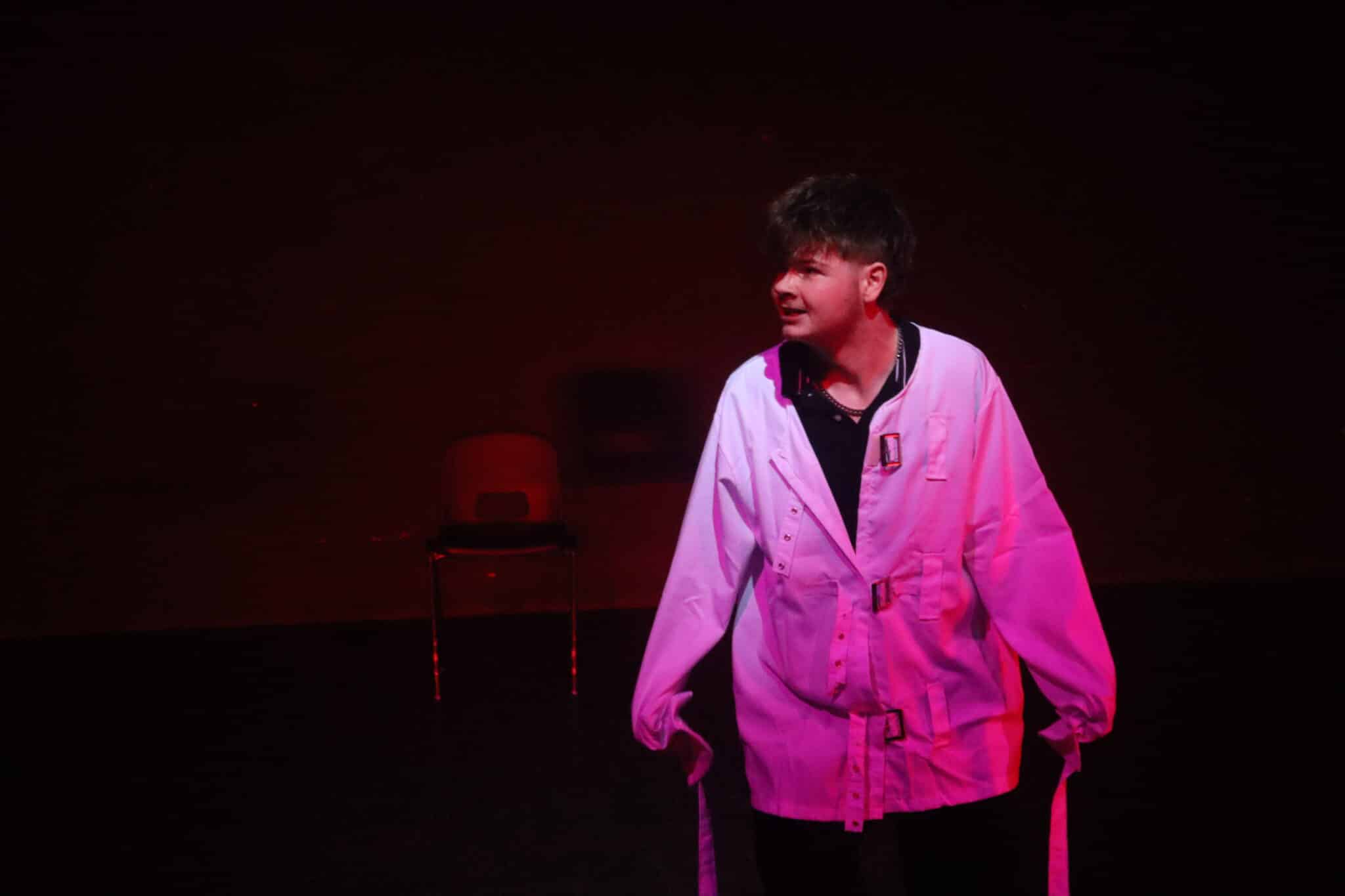 1 student on stage in a straight jacket.