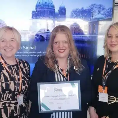 3 women smiling holding a certificate
