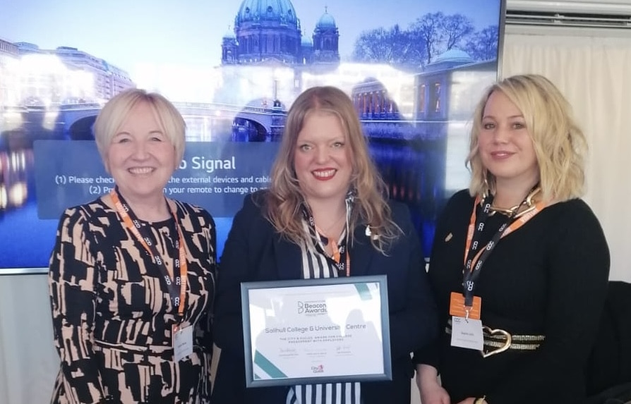 3 women smiling holding a certificate