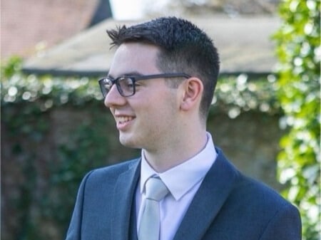 Student in suit smiling