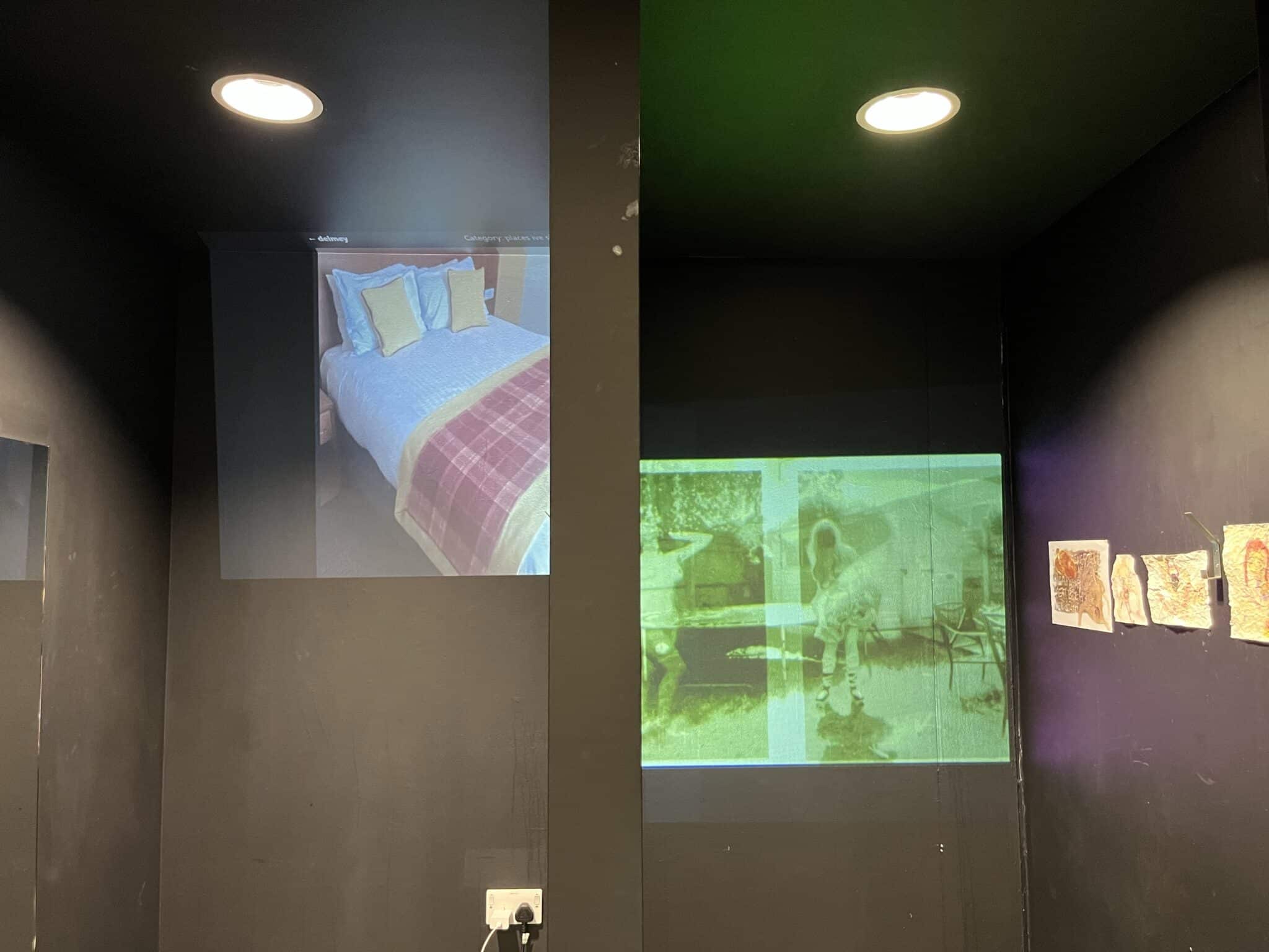 Projections of different types of landscapes on a black wall