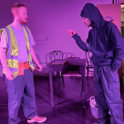 2 people in a purple light fake arguing