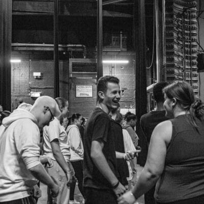 Black and white photo of people back stage of a theatre show