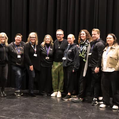Staff standing with Simon Pegg for a group photo