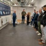 heat pump facility event with attendees listening to information about it.