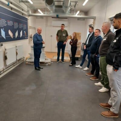 heat pump facility event with attendees listening to information about it.