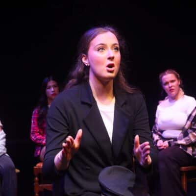 student singing in suit jacket