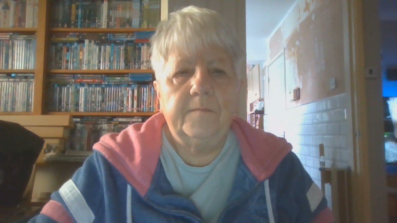 Penelope in front of bookcases