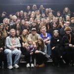 john leader surrounded by students