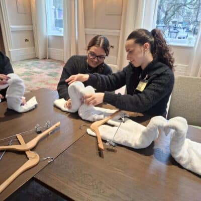 students folding linen