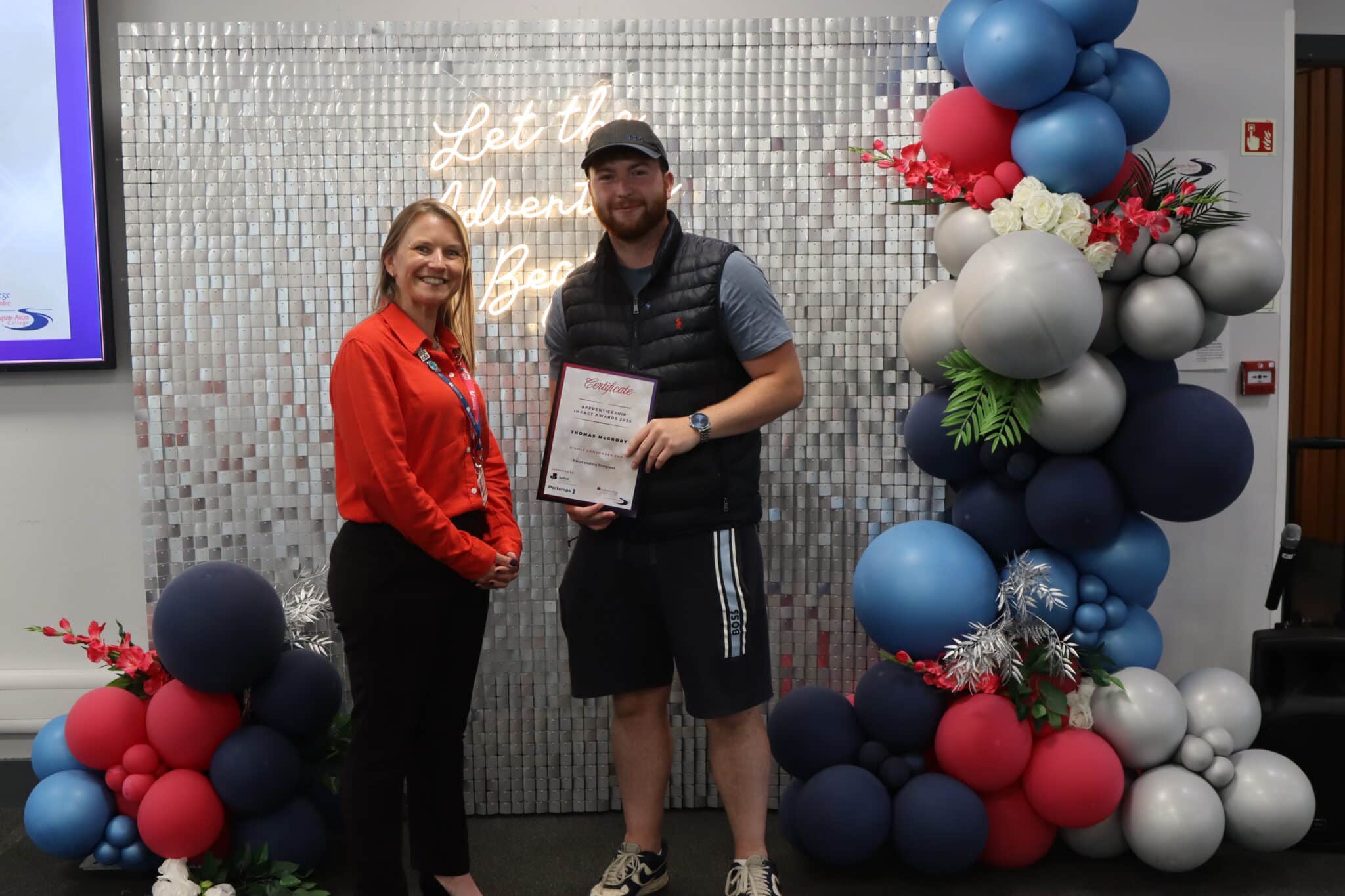 award winner holding certificate looking happy