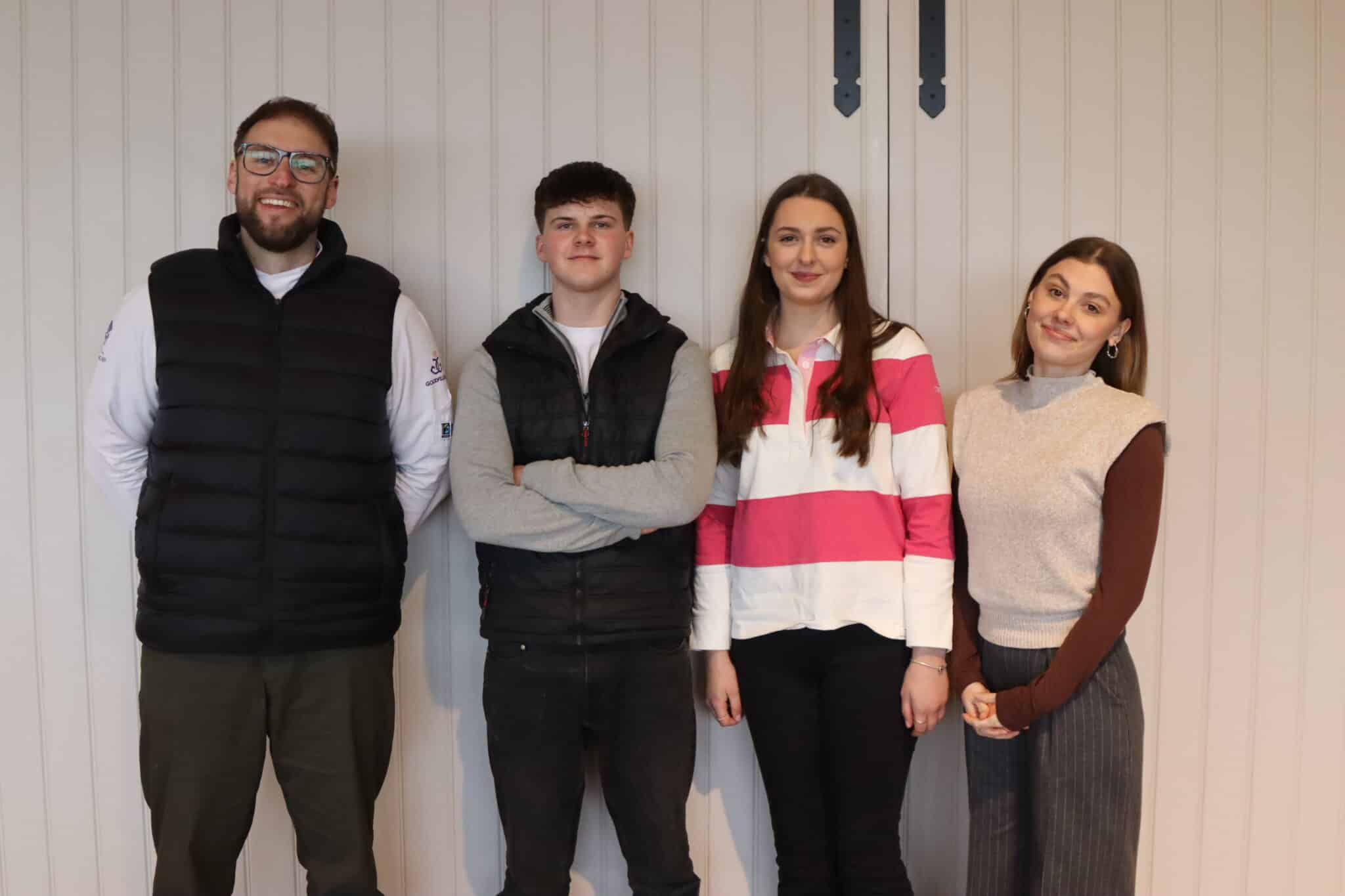 employer and apprentices standing in front of a white wall