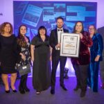 team receiving award on stage