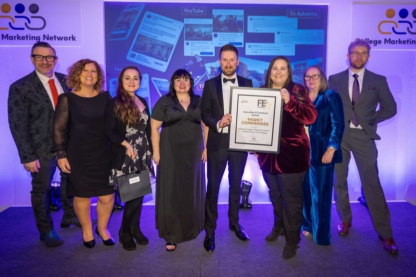 team receiving award on stage