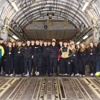 UPS students standing inside an aircraft hanger