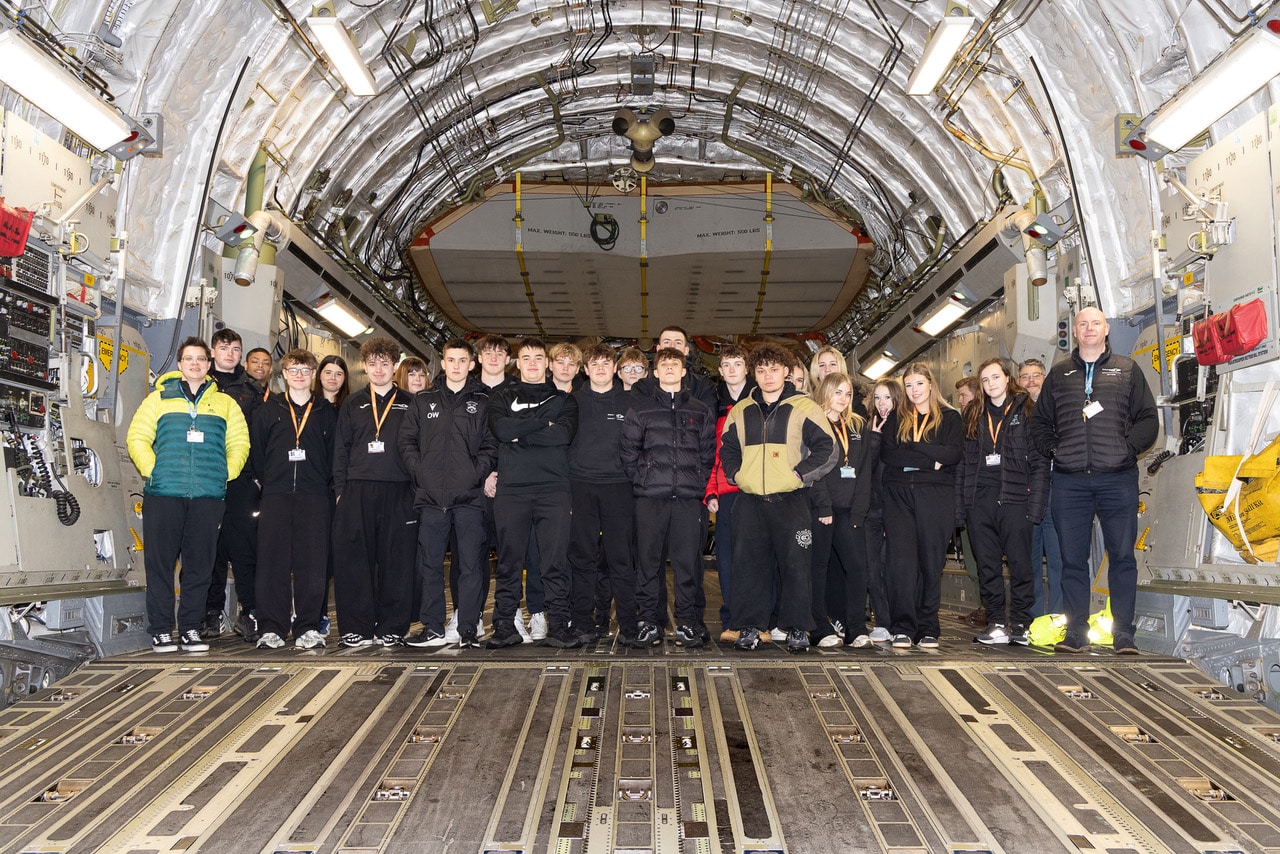 UPS students standing inside an aircraft hanger