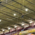 students abseiling in stadium