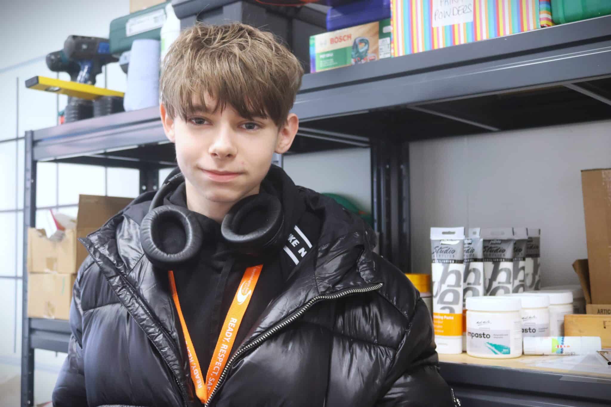 students standing next to art supplies