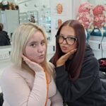 two students in front of a mirror
