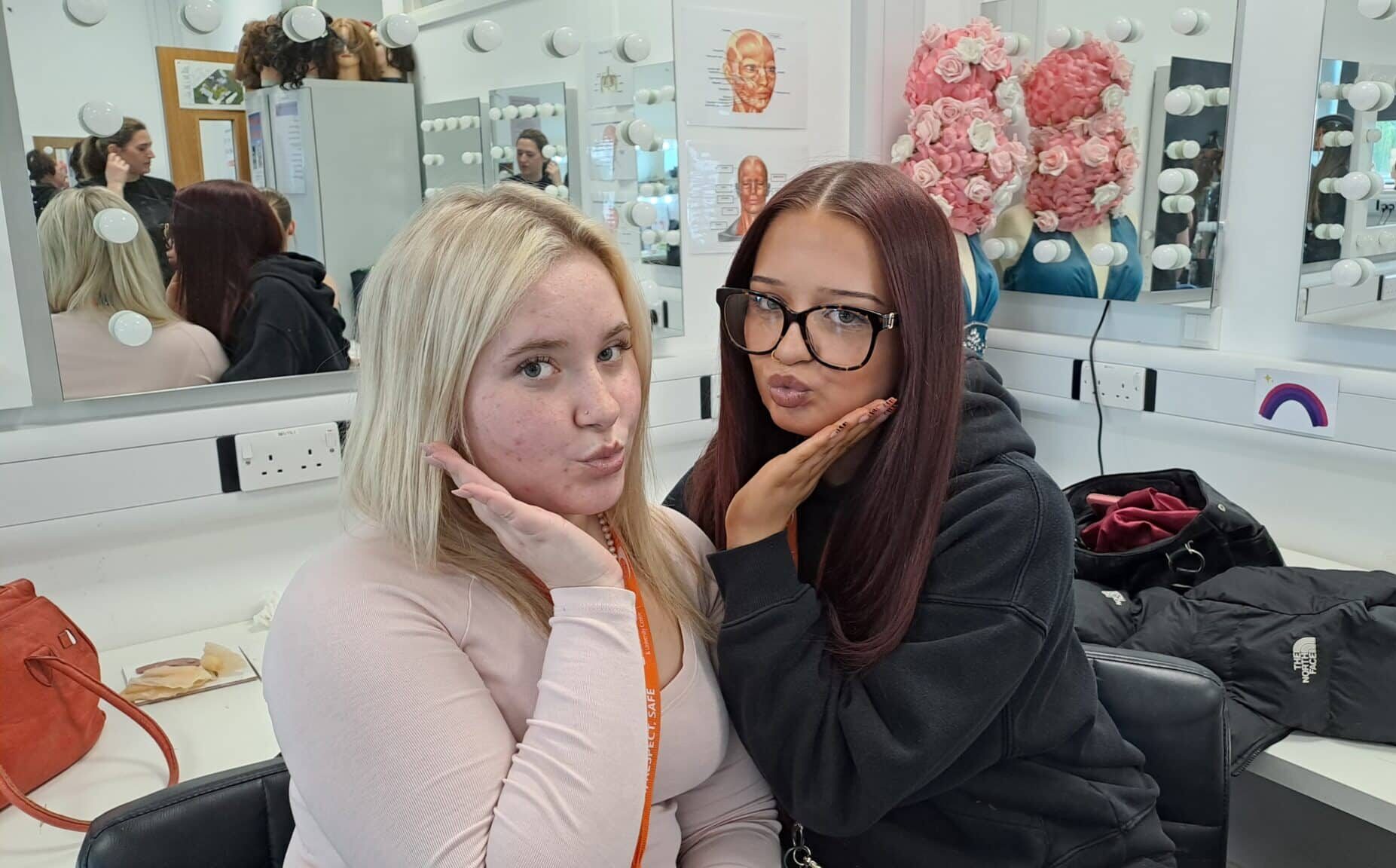two students in front of a mirror