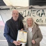 two people standing holding a certificate
