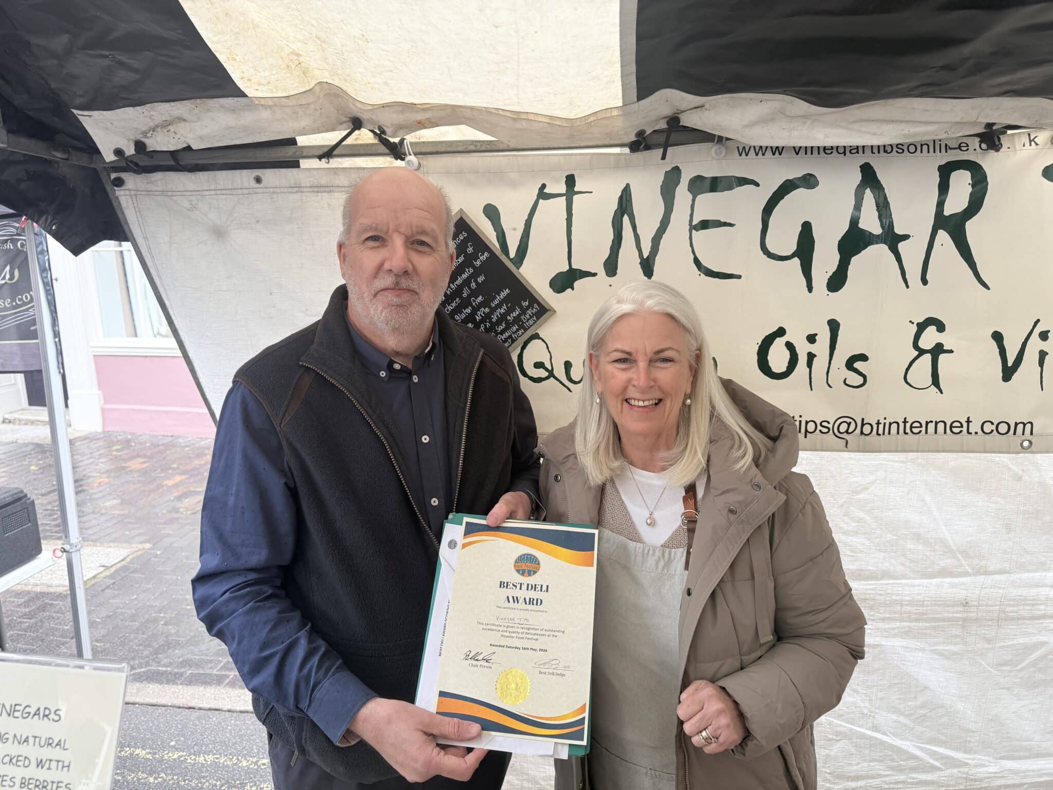 two people standing holding a certificate