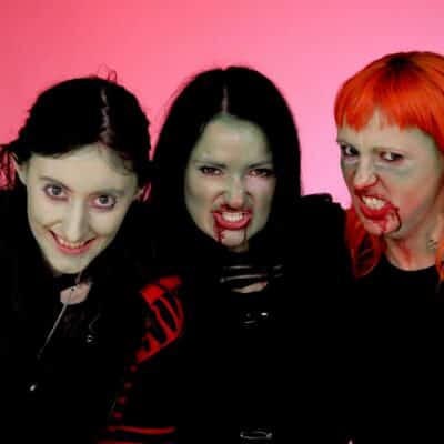 3 zombies against a pink back drop